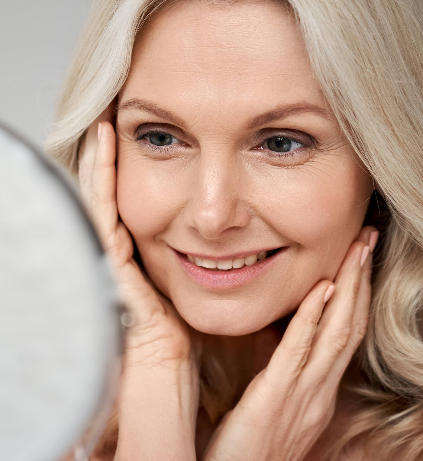 happy-50s-middle-aged-woman-touching-face-skin-loo-2025-02-11-16-20-00-utc (1)