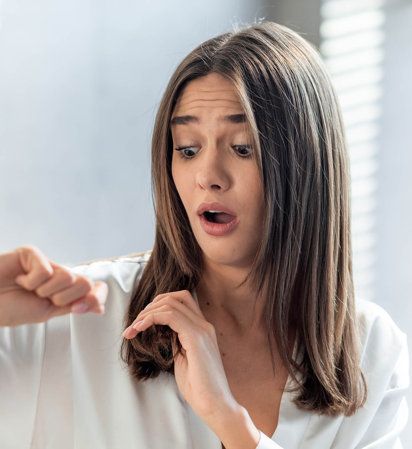 shocked-woman-looking-at-her-dry-brittle-hair-whil-2023-11-27-05-09-34-utc (2)