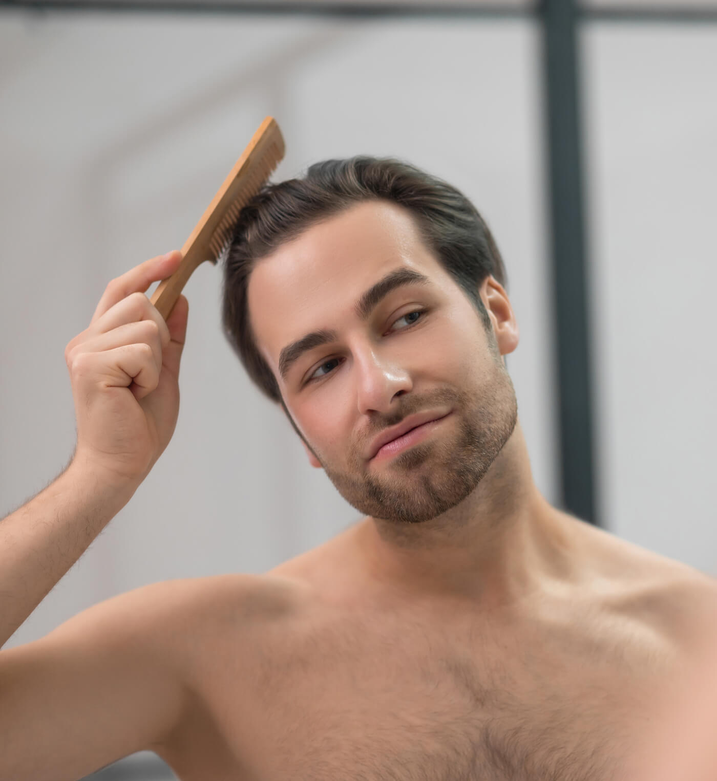 young-handsome-man-brushing-his-hair-and-looking-c-2024-10-16-23-23-08-utc (2)